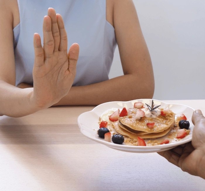 Refusing a plate of pancakes